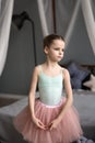 Little girl dreams of becoming a ballerina. Child in a pink tutu dancing in a kids room. Royalty Free Stock Photo