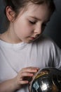 A little girl dreams of a trip while holding a globe in her hands. Royalty Free Stock Photo