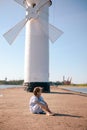 little girl on the beach with developing long blond hair in the wind and looking on the sea Royalty Free Stock Photo