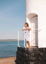 little girl on the beach with developing long blond hair in the wind and looking on the sea Royalty Free Stock Photo