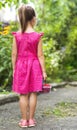 Little girl in dress child hand holdind small basket of ripe raspberries. Close-up Royalty Free Stock Photo