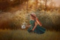 Little girl in dress and hat walking in a green field Royalty Free Stock Photo