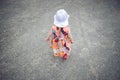 Little girl in dress and white hat walking Royalty Free Stock Photo