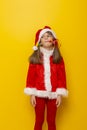 Little girl dressed as Santa blowing party whistle Royalty Free Stock Photo