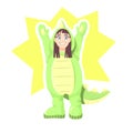 Little girl dressed in jumpsuit in form of dinosaur or dragon