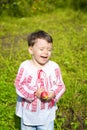 Little girl dressed in Romanian traditional blouse named ie laughing outdoors Royalty Free Stock Photo
