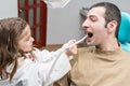 Child heals teeth to an adult Royalty Free Stock Photo