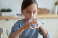 Little girl drink still mineral water feeling thirsty