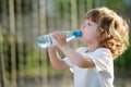 Little girl drinking clean water from plastic Royalty Free Stock Photo