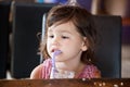 Little girl is drinking milk cocktail Royalty Free Stock Photo