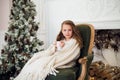 Little girl drinking milk near Christmas tree in morning at home Royalty Free Stock Photo