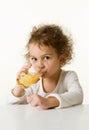 Little girl drinking orange juice