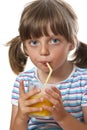 Little girl drinking orange juice Royalty Free Stock Photo