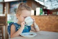 Little girl drinking tea from a cup Royalty Free Stock Photo