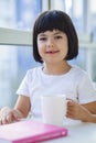 Little girl drinking tea of milk at home Royalty Free Stock Photo