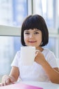 Little girl drinking tea of milk at home Royalty Free Stock Photo