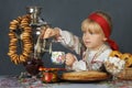 Little girl drinking tea in the traditional russian sarafan and shirt Royalty Free Stock Photo