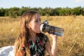 Little girl drinking water from a glass bottle in nature Royalty Free Stock Photo