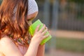 Little girl drinking water from a glass in the park Royalty Free Stock Photo