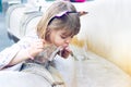 Little girl drinking water on public fountain Royalty Free Stock Photo