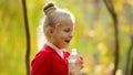 Little girl drinks clean water in the outdoors. Little girl drinks clean water in autumn Park. Healthily concept. Healthy