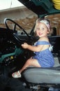 Little girl in driver's seat of big rig truck