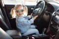 Little girl in the driver`s seat driving a car Royalty Free Stock Photo