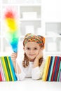 Little girl dusting in her room