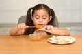 Little Girl Eating Apple With Honey. Symbol of the Jewish New Year Rosh haShana. Royalty Free Stock Photo