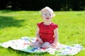 Little girl eating berries in the garden