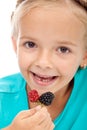 Little girl eating blackberries Royalty Free Stock Photo