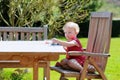 Little girl eating blueberries outdoors