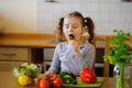 Little girl eating broccoli.