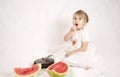 Little girl eating a cake and watermelon Royalty Free Stock Photo