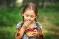 Little girl eating cherries from a basket on nature Royalty Free Stock Photo