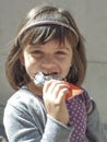 Little girl eating a chocolate bar Royalty Free Stock Photo