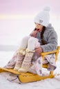 Little girl eating colorful lollipop candy on stick in winter outdoor Royalty Free Stock Photo