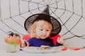 Little girl eating cookies on halloween, kids trick or treating