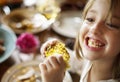 Little Girl Eating Corn Thanksgiving Celebration Concept