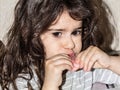 Little girl eating delicious sausage. child nutrition issues. Royalty Free Stock Photo