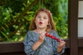 Little girl eating delicious strawberries on skewers, savoring the simple pleasures of family and healthy food. Happy Royalty Free Stock Photo