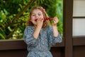 Little girl eating delicious strawberries on skewers, savoring the simple pleasures of family and healthy food. Happy Royalty Free Stock Photo