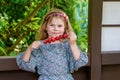 Little girl eating delicious strawberries on skewers, savoring the simple pleasures of family and healthy food. Happy Royalty Free Stock Photo