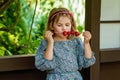 Little girl eating delicious strawberries on skewers, savoring the simple pleasures of family and healthy food. Happy Royalty Free Stock Photo