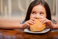 Little girl eating a hamburger