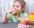 A little girl is eating her lunch at school. Lunch schoolgirl. Toast and and fresh juice and salad for a healthy dinner. Free Royalty Free Stock Photo