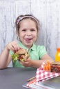 A little girl is eating her lunch at school. Lunch schoolgirl. Toast and and fresh juice and salad for a healthy dinner. Free Royalty Free Stock Photo