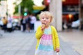 Little girl eating ice cream walking in the city Royalty Free Stock Photo