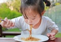 Little girl eating Japanese yakisoba noodles