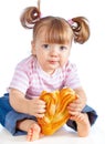 Little girl eating a loaf of bread